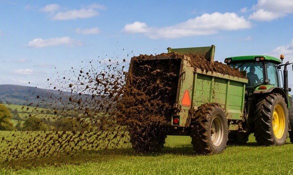 Tracker spreading muck on the field ready for the Cumbia meeting.